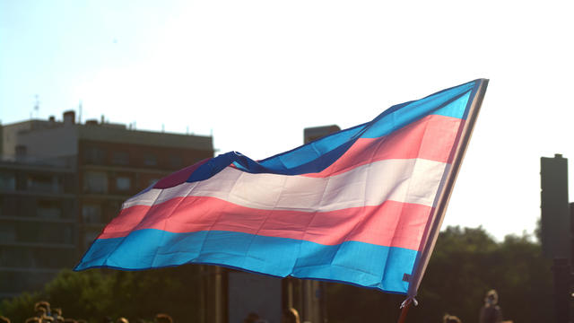 People attend a ceremony at Queens Park for Trans day of remembrance. 