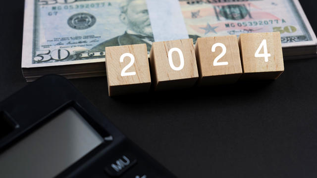 New Year 2024 Concept with Paper Money and Calculator 